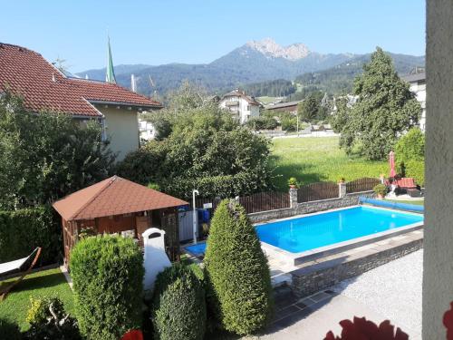 a swimming pool in the backyard of a house at Gästehaus Alpenblick in Mutters