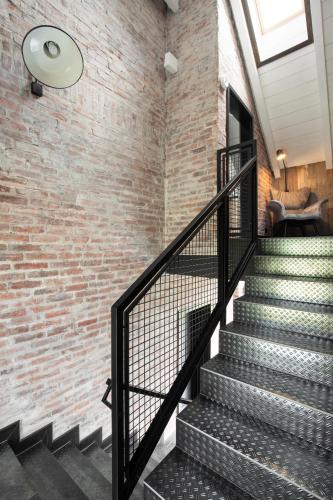 a staircase in a brick wall with a ceiling at Bieszczadzka Stodoła in Ustrzyki Dolne