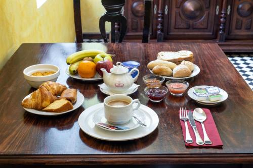 a table with breakfast foods and a cup of coffee at Hotel Sao Joao De Deus by RIDAN Hotels in Elvas