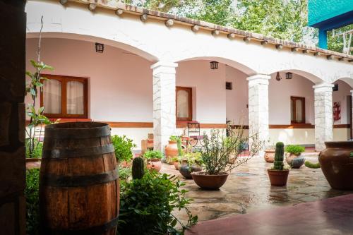 a courtyard with potted plants and a building at Azul Humahuaca Hostal in Humahuaca