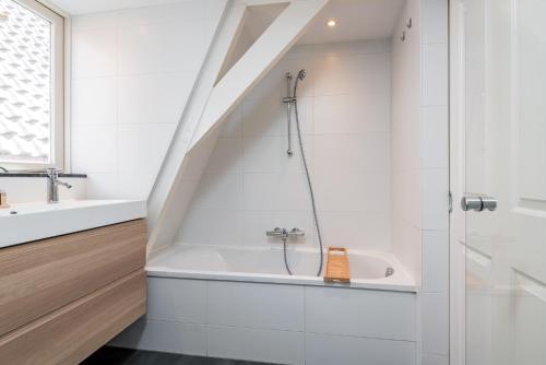 a bathroom with a shower and a bath tub at Charming Apartments in Alkmaar