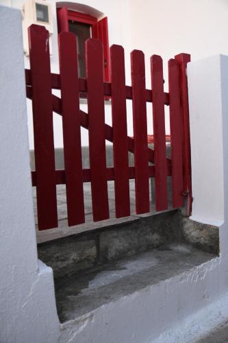 a red fence on the side of a building at Verantaki in Kithnos
