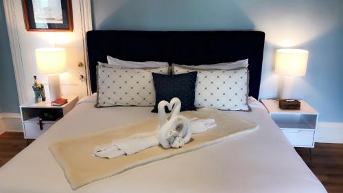 a hotel room with a bed with towels on it at Peace & Plenty Inn Bed and Breakfast Downtown St Augustine-Adults Only in Saint Augustine