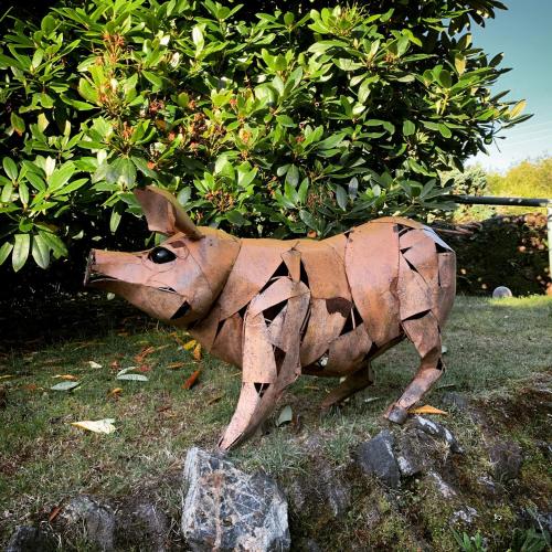 a statue of a cow standing in the grass at Boscundle Manor in St Austell