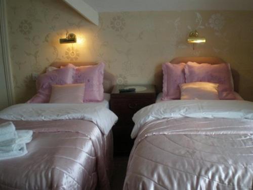 two beds sitting next to each other in a room at The Brockton in Bridlington