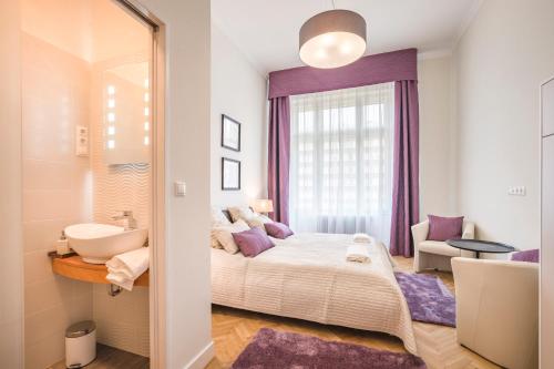 a bedroom with a bed and a sink and a sink at MODERNIZED Unique Huge Central Apartment On 135sqm in Budapest