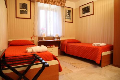 a bedroom with two beds and a window at B&B Villa Casablanca in Enna