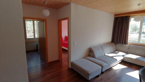 a living room with a couch and a table at Ufem Egg Ferienwohnungen in Innertkirchen
