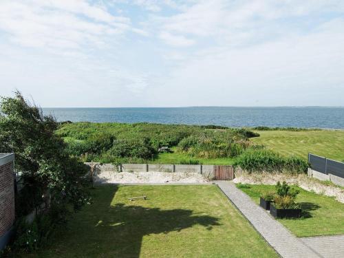 a backyard with a view of the ocean at 4 person holiday home in Esbjerg V in Esbjerg