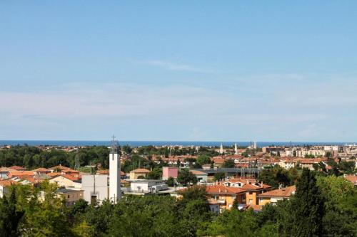a view of a city with buildings and a tower at Castello Montegiove in Fano