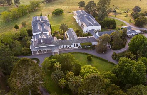 an aerial view of a large house with a yard at Chateau Yering in Yarra Glen