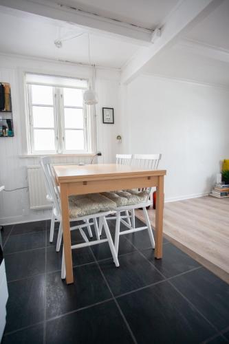 a dining room with a wooden table and chairs at Two Bedroom Vacation Home in the Center of Tórshavn in Tórshavn