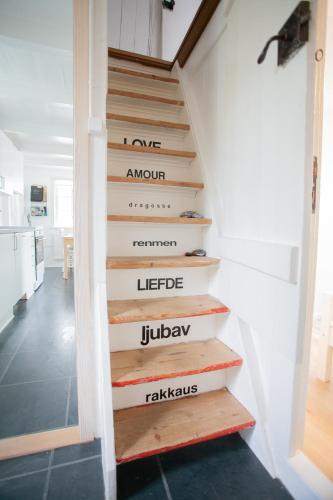 a staircase with the words one arrow premier premier leeperlee juleley at Two Bedroom Vacation Home in the Center of Tórshavn in Tórshavn