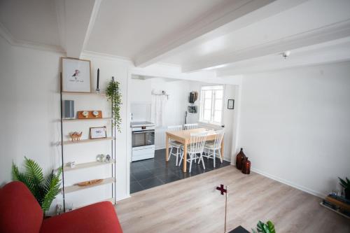 a living room with a table and a kitchen at Two Bedroom Vacation Home in the Center of Tórshavn in Tórshavn