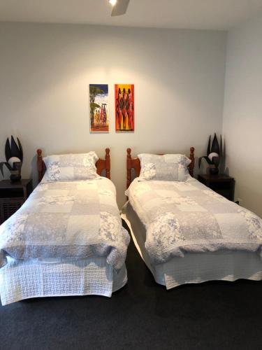 two beds sitting next to each other in a room at The Glen in Raleigh