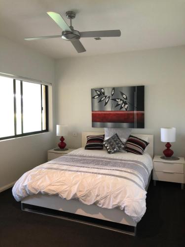 a bedroom with a bed with a ceiling fan at The Glen in Raleigh