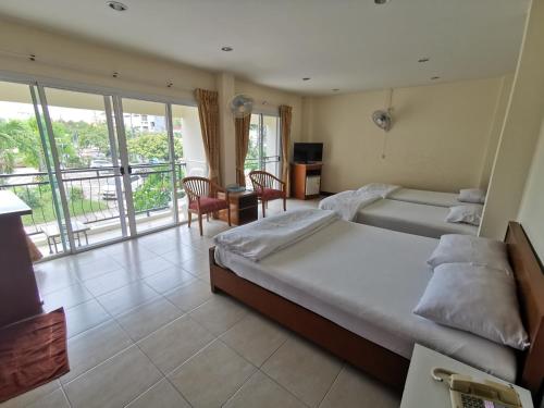 a bedroom with a large bed and a balcony at Subhamitra Hotel Hua Hin-SHA Certified in Hua Hin