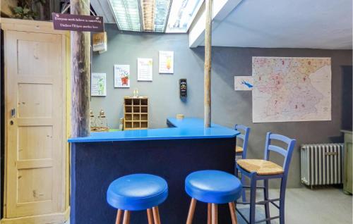 a bar with blue stools in a room with a map at Nice Home In Gottmadingen With Wifi in Gottmadingen