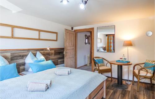 a bedroom with a bed and a table and chairs at Nice Home In Gottmadingen With Wifi in Gottmadingen