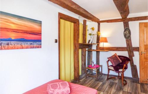a room with a bed and a chair and a painting at Nice Home In Gottmadingen With Wifi in Gottmadingen