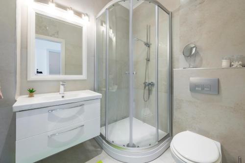 a bathroom with a shower and a toilet and a sink at Villa Hortensia-With Private Pool and Beaches Front in Mlini