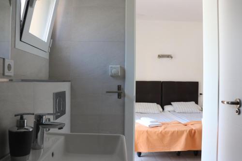 a bathroom with a sink and a bed in a room at Amistad in Paguera