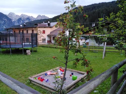 a small tree in a sandbox in a yard at B&B DeBy & E-Bike Rental in San Nicolò di Comelico