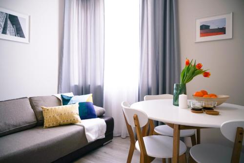 a living room with a couch and a table at So Close Kapana - 2 Rooms Central Apartments in Plovdiv