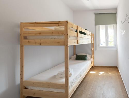 a bedroom with two bunk beds in a room at Maka beach apartment v in Castelldefels