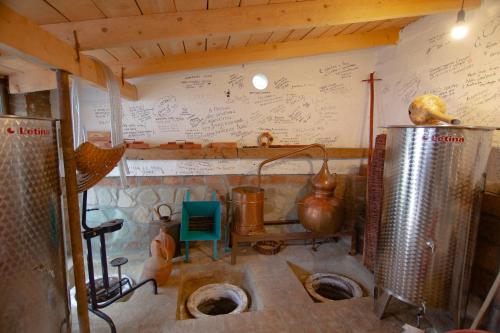 a kitchen with two toilets in a room with a wall with drawings at Milorava's Guest House & Wine Cellar in Telavi