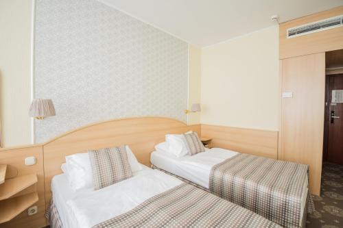 Postel nebo postele na pokoji v ubytování Hotel Orion Várkert