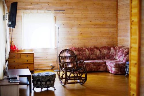 a living room with a couch and two chairs at Tihaya Dolina in Kappanen