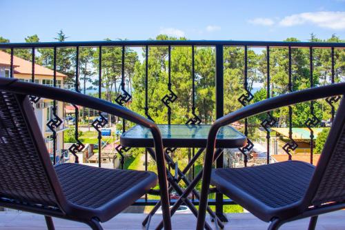 two chairs and a table on a balcony at Magnetic Resort Ureki in Ureki