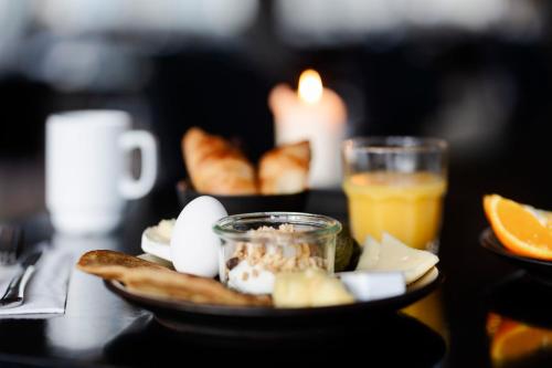 a plate of food with eggs and bread on a table at CPH Hotel in Copenhagen
