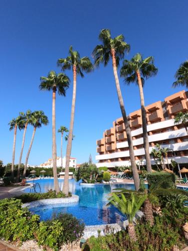 ein Resort mit Palmen und einem Pool in der Unterkunft Arena Center in Roquetas de Mar