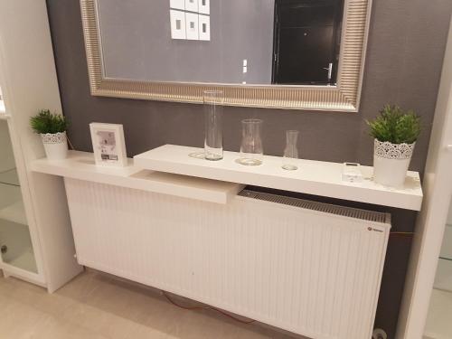 a bathroom with a white counter with a mirror at Second Home in Amman