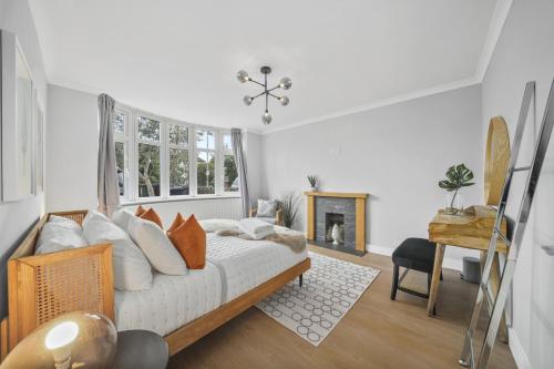 a bedroom with a bed and a fireplace at Clarence House-Windsor-Parking-5 bed in Windsor