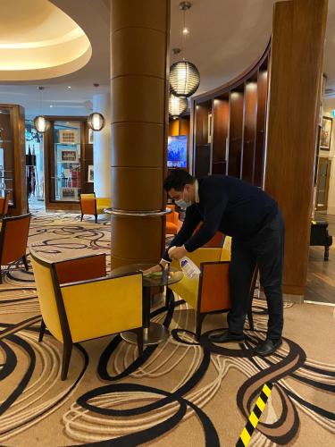 a man bending over a table in a hotel lobby at Hard Days Night Hotel in Liverpool