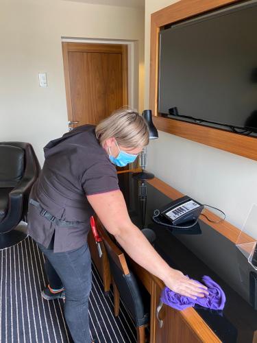 a woman in a room with a mask on at Hard Days Night Hotel in Liverpool