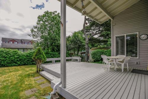 a deck with a table and chairs on a house at Gaea House in Seaside