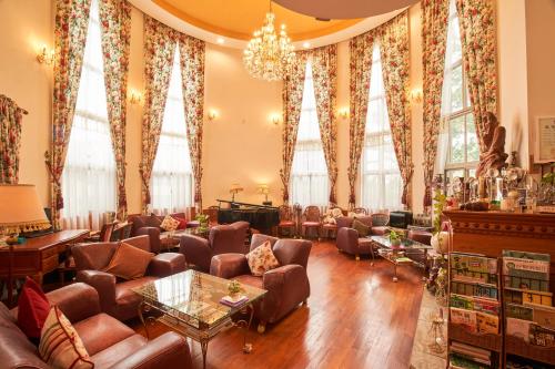 a living room with couches and tables and windows at Memory Garden in Luodong