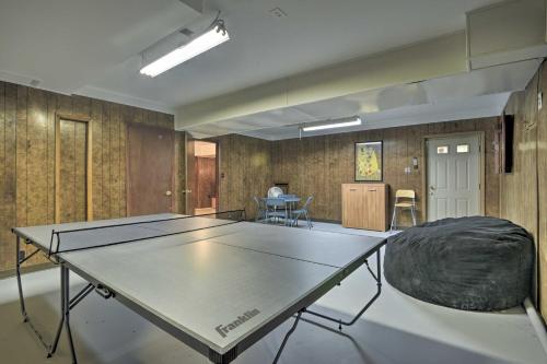 a ping pong table in the middle of a room at Lake and Golf Retreat with Dock and 2 Luxury Decks! in Sanford
