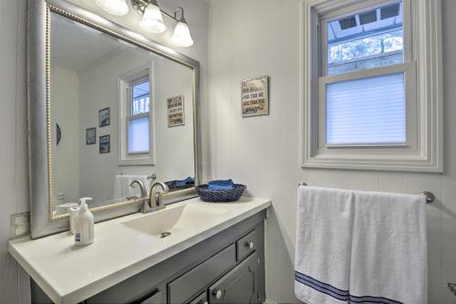 a bathroom with a sink and a large mirror at Lake and Golf Retreat with Dock and 2 Luxury Decks! in Sanford