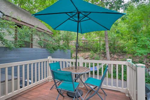 a table with two chairs and an umbrella on a porch at Creekside Home with Patio, Walk to Manitou Incline! in Manitou Springs
