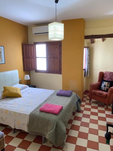 a bedroom with a bed with two towels on it at Casa Rural Hotel La Placeta AYORA in Ayora