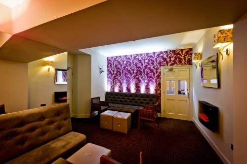 a hotel room with a couch and a table at The Parklands Hotel in Perth
