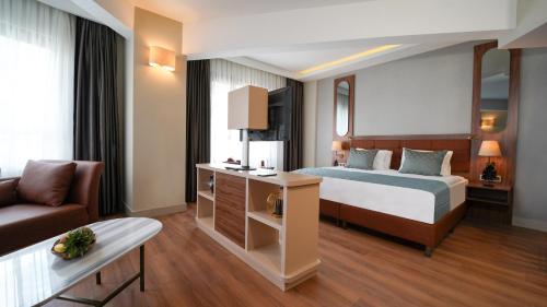 a hotel room with a bed and a couch at Grand Sirkeci Hotel in Istanbul