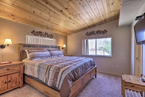 a bedroom with a large bed with a wooden ceiling at Rustic Bullhead City Retreat with Porch and Views in Bullhead City