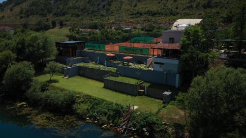 an aerial view of a building next to a river at Hotel RIO VERDE in Podgorica