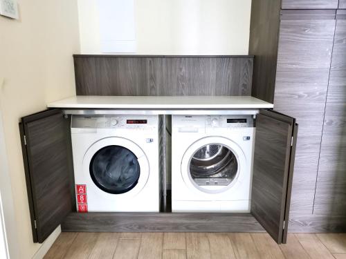 a laundry room with a washer and dryer at THE VIEW!!! by Design Studio in Perledo